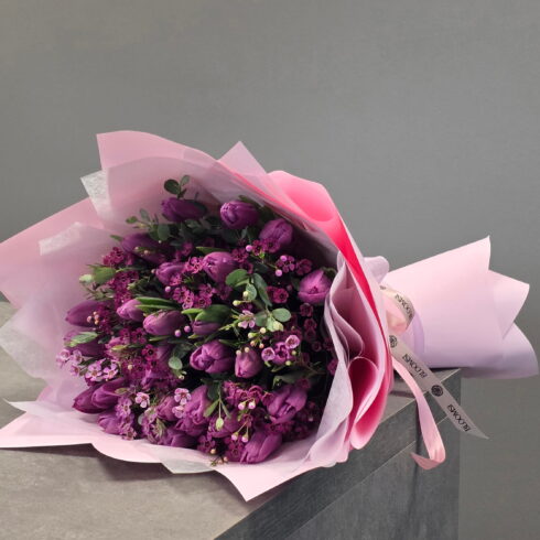 Luxury purple tulips and wax flower hand-tied bouquet in blush wrapping by BLOOMSI Oakville
