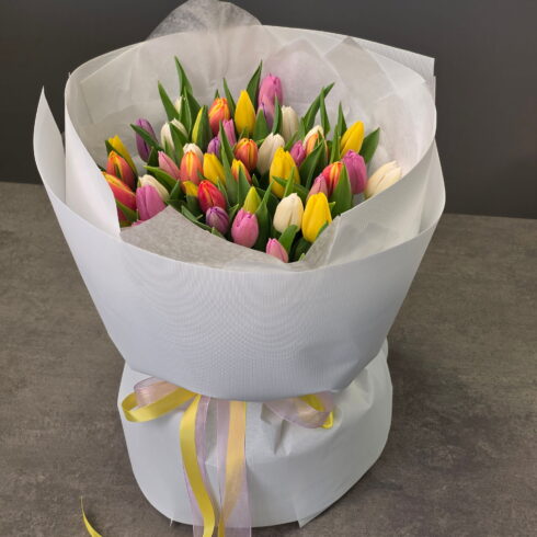 Colorful spring tulips bouquet with yellow pink white and purple tulips wrapped in elegant paper – flower delivery Oakville Mississauga