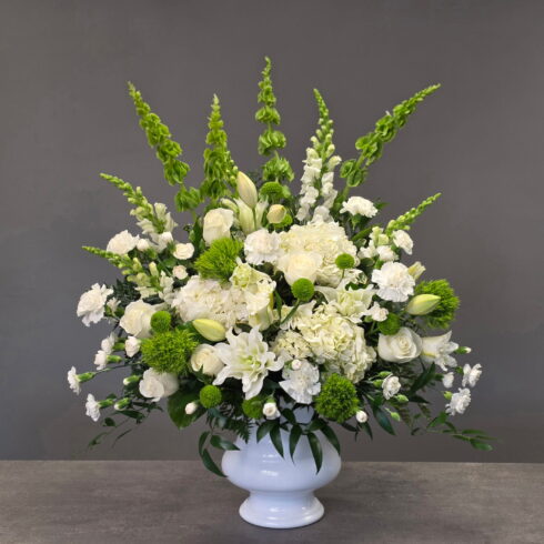traditional white funeral flower arrangement with roses lilies hydrangea Oakville