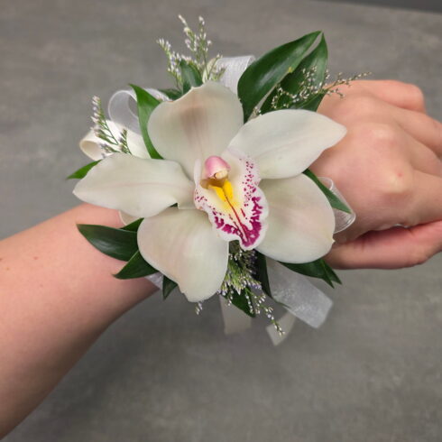 Luxury white orchid wrist corsage handcrafted by BLOOMSI for prom, graduation, weddings, and special events