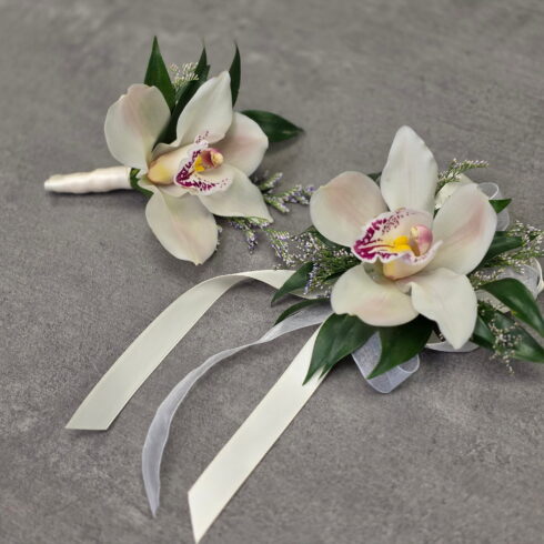 Luxury white orchid corsage and boutonniere set handcrafted by BLOOMSI for prom, weddings, graduation, and formal events